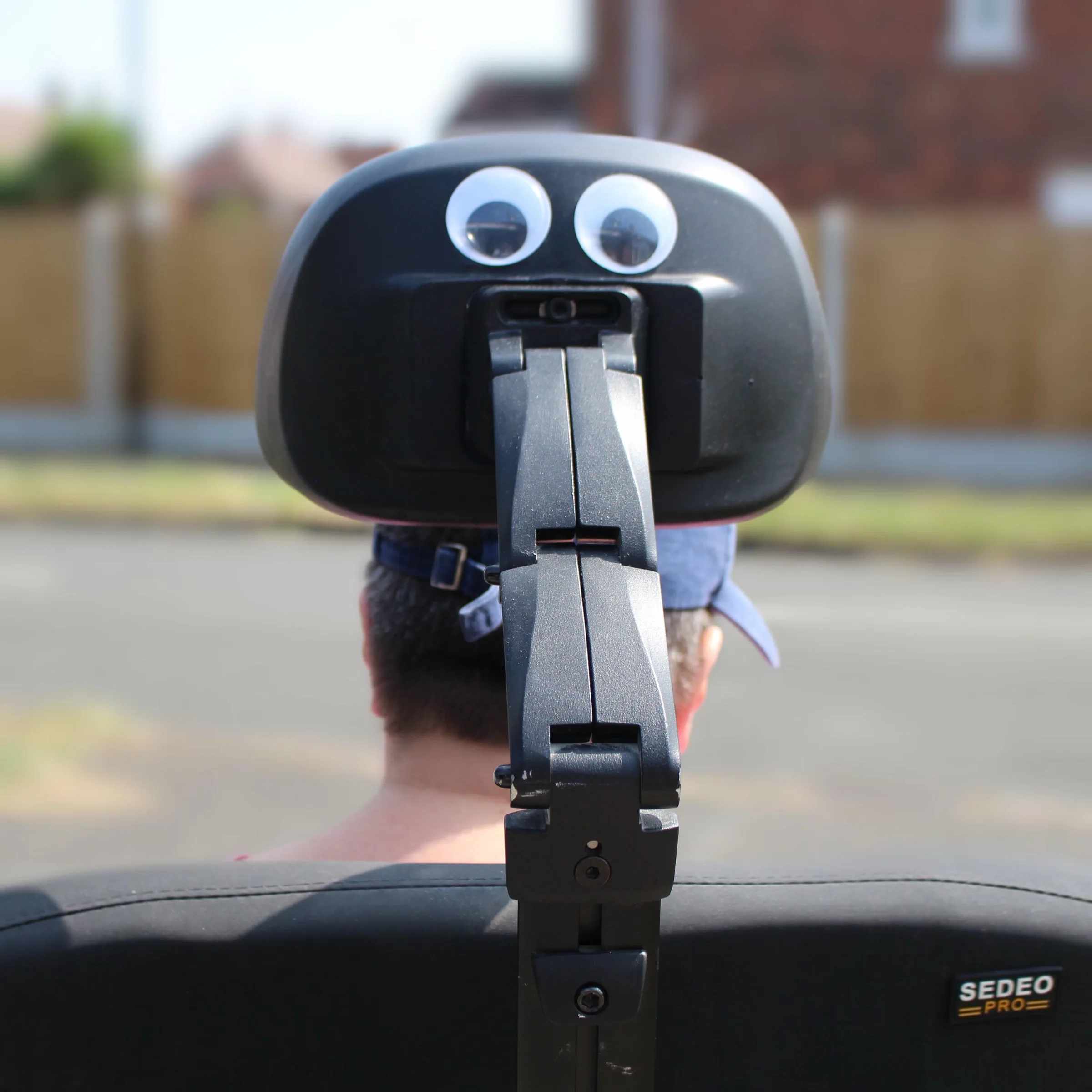 A client's wheelchair headrest decorated with googly eyes during a day out with Britz Healthcare in Doncaster